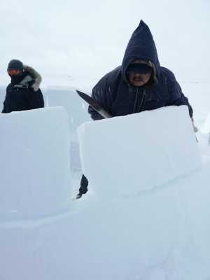 Peter Boy Itukalla builds an igloo in white-out conditions in Nunavik, Canada