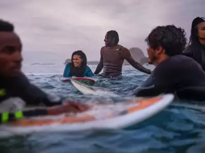 Surfers at Maiden's Cove in Cape Town, South Africa