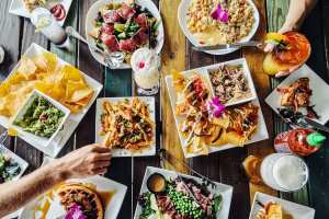 Food and drinks on a multicoluored wooden table