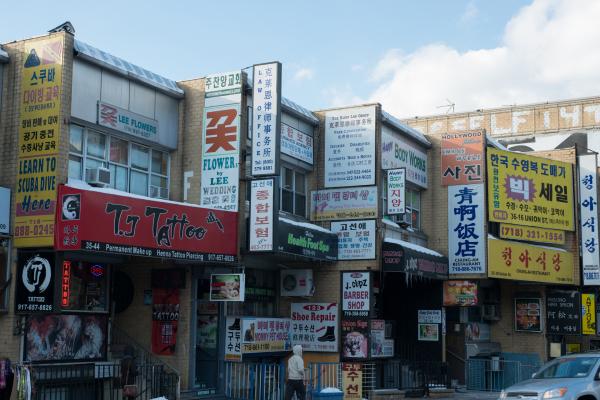 Bilingual shop signs on a street in Flushing’s Chinatown