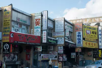 Bilingual shop signs on a street in Flushing&rsquo;s Chinatown