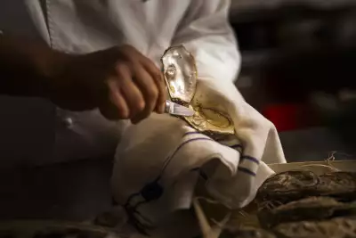 Chef Ettore Bocchia shucking an oyster