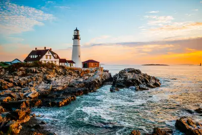 A summer sunrise at one of Maine’s most popular lighthouses, Portland Head Light in Cape Elizabeth