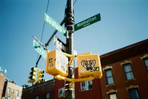 A traffic intersection near Frankel’s Delicatessen in Greenpoint with New York’s iconic green street signs A traffic intersection near Frankel’s Delicatessen in Greenpoint with New York’s iconic green street signs