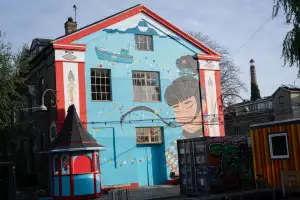 A mural of a Greenlandic woman on Pusher Street, Christiania