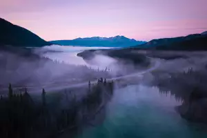 Morning mist rises from the surface of Emerald and Spirit Lakes