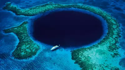 A boat passing over the Great Blue Hole of Belize