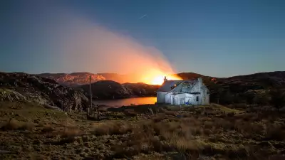Fire behind a dilapidated croft on Harris
