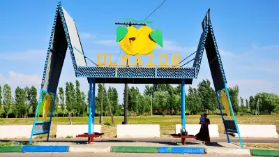 Dual triangle bus stop in Uzbekistan with lemon advertisment