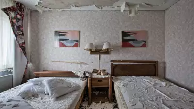 Two beds in a vandalised room in Niagara Falls
