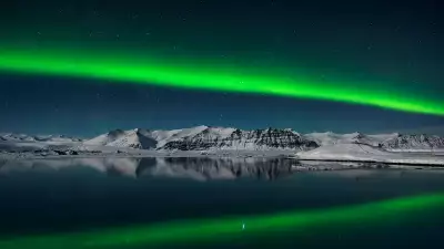 The awe-inspiring sight of the Northern Lights streaking across the night sky over the lagoon at Jokulsarlon, Iceland