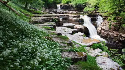 View through the grass to the Kisdon Force waterfalls near Keld