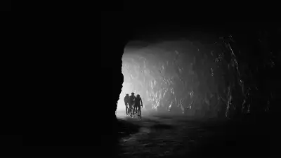 Cyclists coming into a tunnel in black and white in France