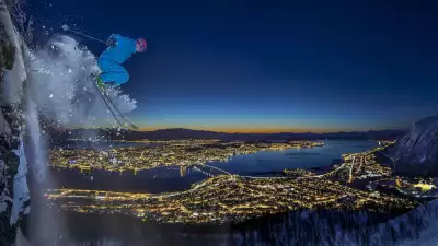 Skiier jumping off a clifftop in Tromso, Norway