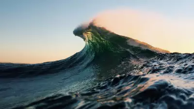 Light glowing through the top of an incoming wave
