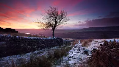 View of a snow-covered valley at sunset