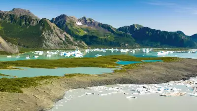 Female hiker overlooks Bear Glacier Lake in Kenai Fjords National Park, Kenai Peninsula, Southcentral Alaska