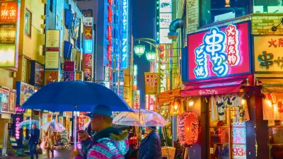 Tourists with umbrellas in Tokyo, Japan