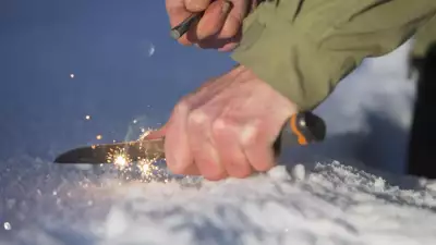 Striking fire with a knife and flint