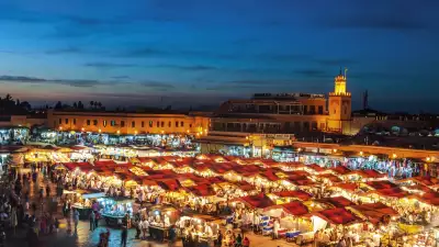 Evening at Djemaa El Fna Square with Koutoubia Mosque, Marrakech, Morocco