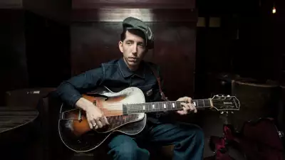 Press shot of Pokey Lafarge playing guitar