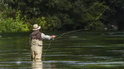 Fly fishing in a chalkbed stream in the Test Valley, Hampshire