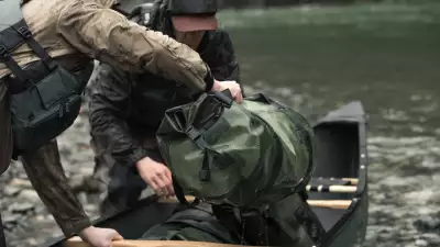 Loading a Filson dry duffel bag into a canoe