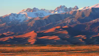 Best adventure holidays | Alpenglow on Dunes and Sangre de Cristo Mountains, New Mexico