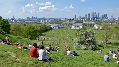 View across Greenwich Park taking in The Shard, the City of London, River Thames, National Maritime Museum, Queen's House, the Old Royal Naval College, and Canary Wharf. Greenwich Park, Greenwich, London