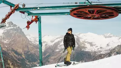 A splitboarder atop the abandoned chairlift in Gaver, Italy