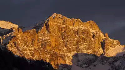 Enrosadira (alpenglow) on the mountain face in The Dolomites