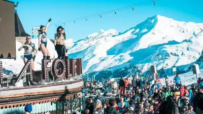 Dancers perform on the roof of La Folie Douce to hundreds of skiers