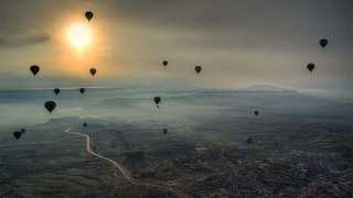 Hot air balloons over a city