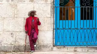 A man smoking a cigar on the street in Cuba
