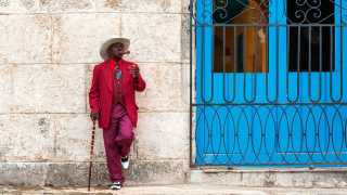 a man smoking a cigar on the street in Cuba