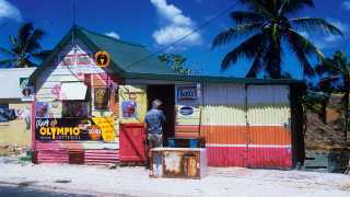 Rum Shack in Barbados with blue sky and palms