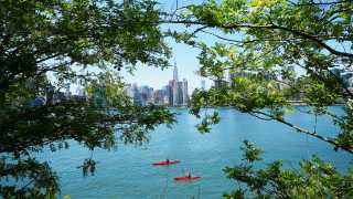 Kayakers and manhattan seen through trees
