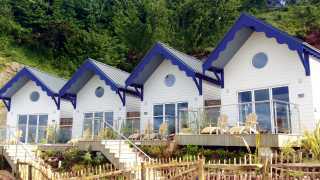 Blue and white beach huts at the Cary Arms