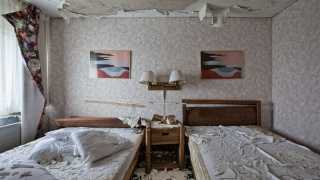 Two beds in a vandalised room in Niagara Falls