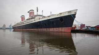 Full exterior shot of the SS United States in harbour