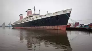 Full exterior shot of the SS United States in harbour