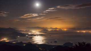 The moon glowing over Paraty Bay, Brazil