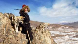 A nomad with tamed wolves in Olgii province, Mongolia