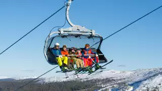 Family on a ski lift in Sweden