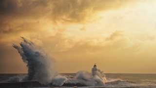 Huge waves hit the pier wall and lighthouse at Seaham Harbour, Durham