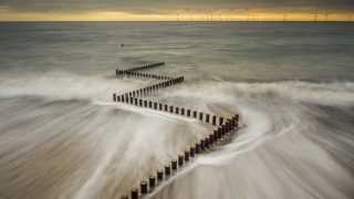 Slow shutter speed shot of a wave drawing back at Caister-on-sea