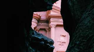 The Treasury in Petra through the narrow 'Siq' path through the rocks