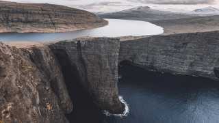 The clifftop lake and sea in Sørásvatn, Faroe Islands
