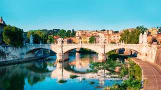 St. Angelo Bridge (Ponte Sant Angelo) and the Trastevere district in Rome with River Tiber