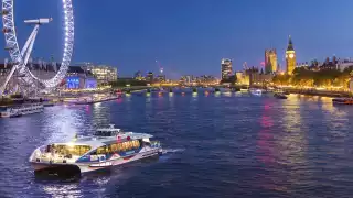 MBNA Thames Clippers boat on the Thames in the evening